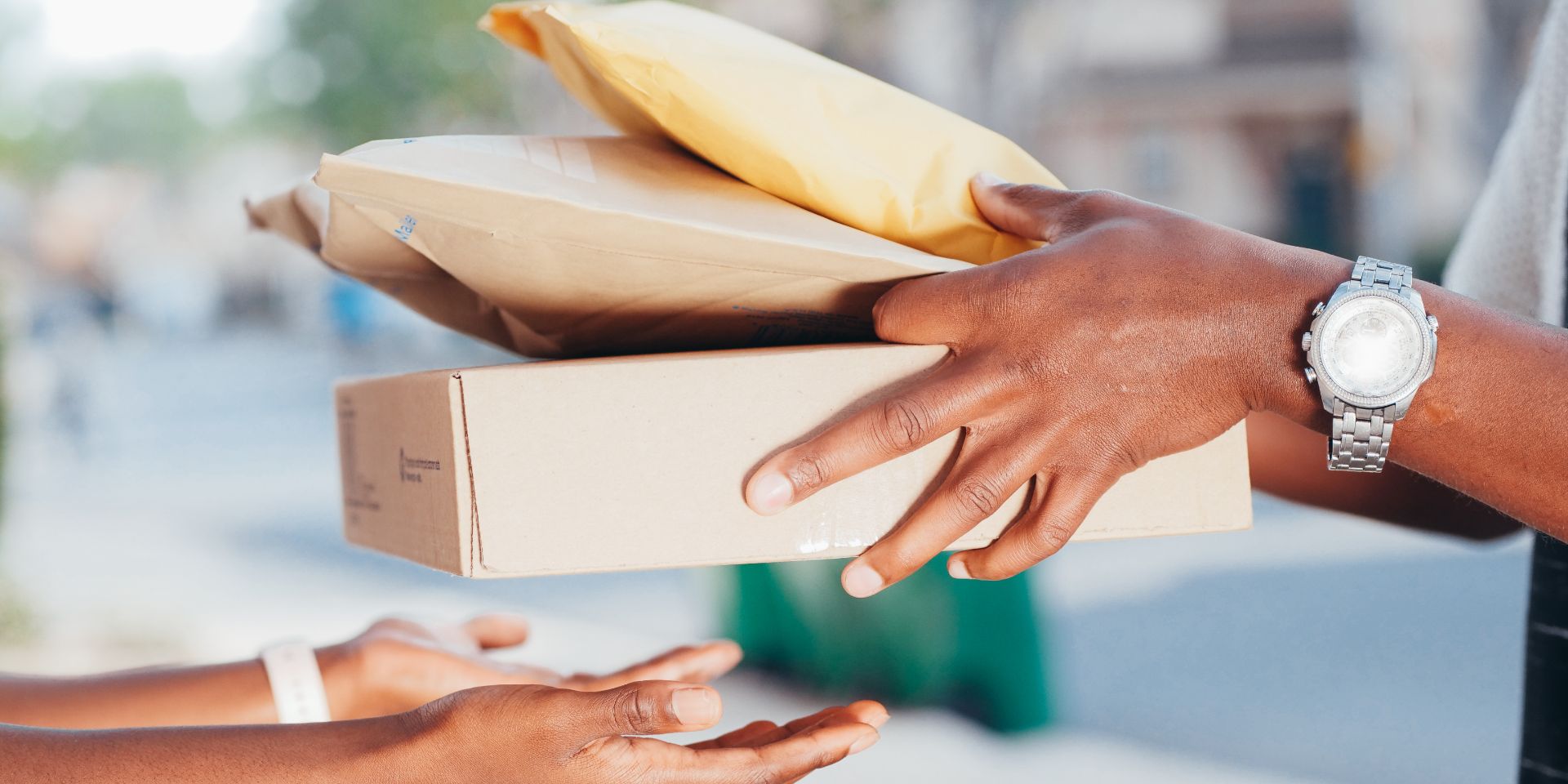 A person handing off small packages to another person